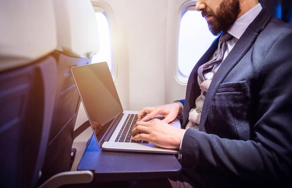 man-working-on-laptop-during-flight-2026-01-05-06-10-59-utc (1)
