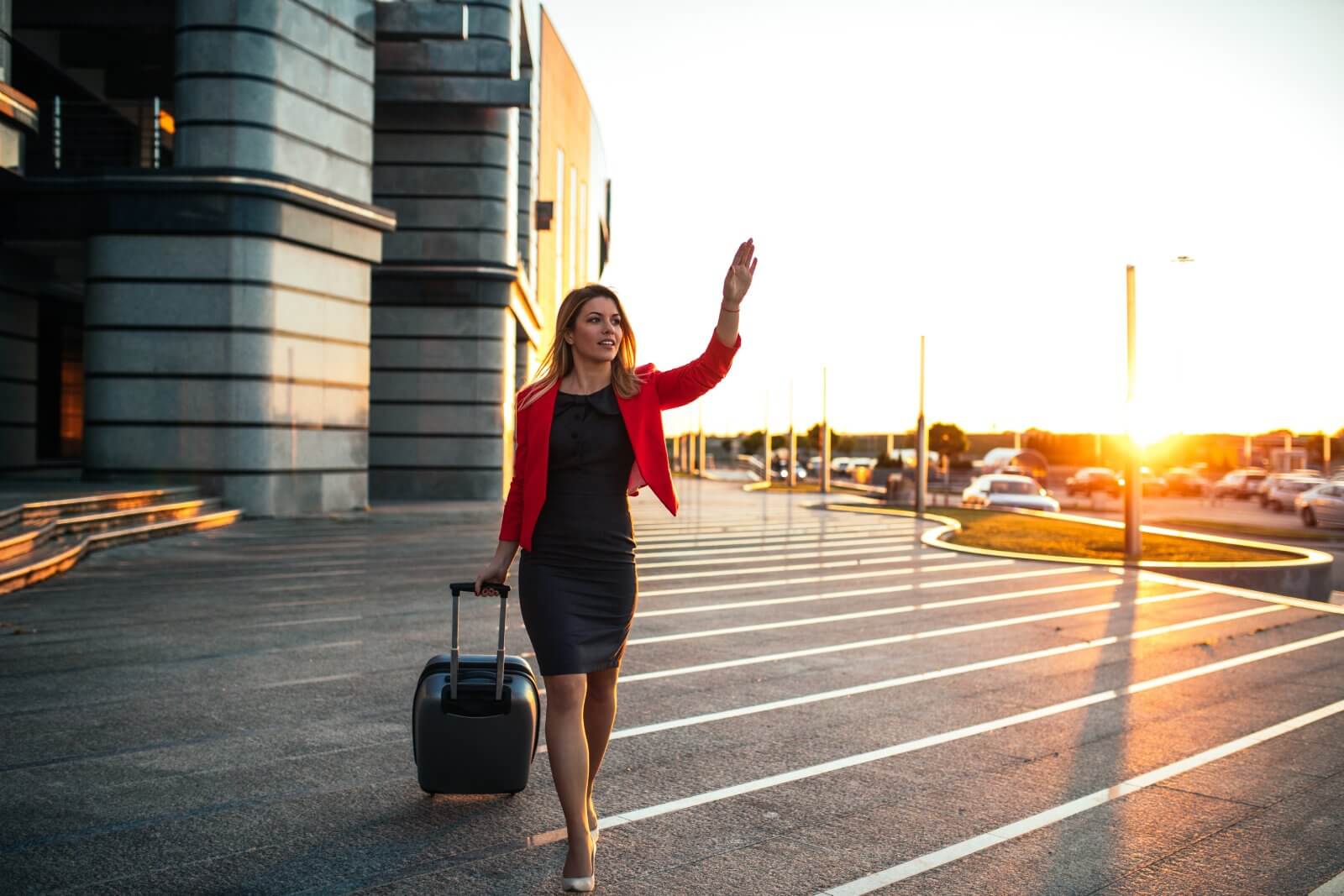 professional-woman-waves-while-walking-with-rollin-2026-01-05-06-02-58-utc (1)
