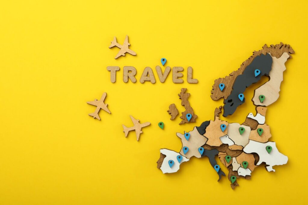 wooden-europe-map-with-airplanes-on-yellow-backgro-2026-01-09-07-51-11-utc (1)