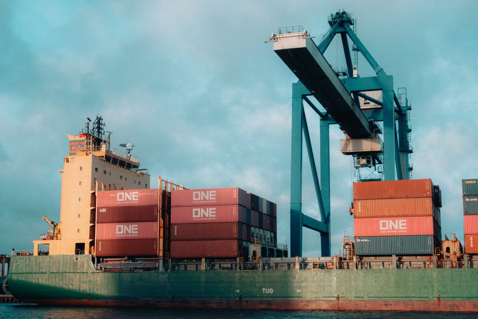 international cargo ship loaded with containers at a busy port preparing for overseas shipment
