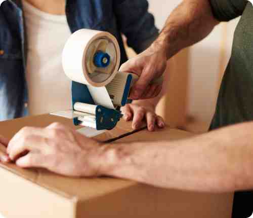 family packing boxes for international move in American home, Chicago suburb